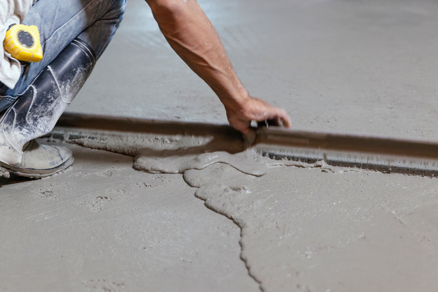 contractor repairing concrete flooring